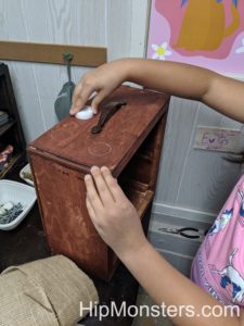 Making our DIY wooden cabinet's wood look distressed. 