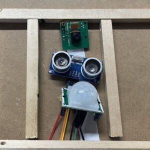 Electronic sensors in a wooden frame.